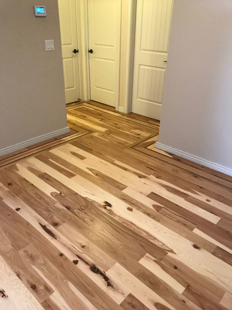mixed light and dark hickory hardwood floors entry way