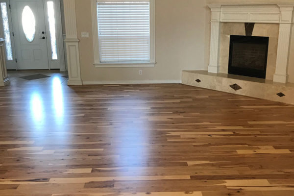 hickory hardwood floors in living room with fireplace