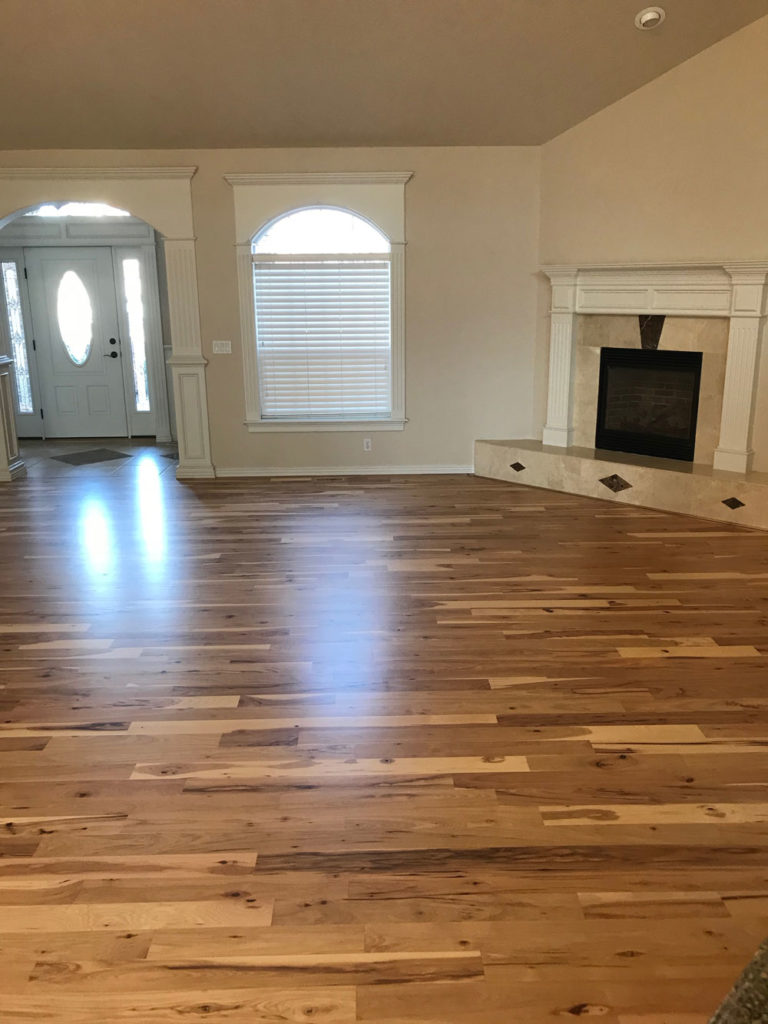 hickory hardwood floors in living room with fireplace