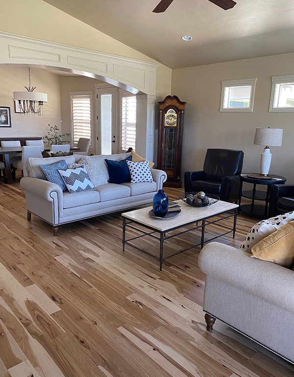 light and dark colored hickory hardwood flooring in clean furnished living room in Boise, ID.