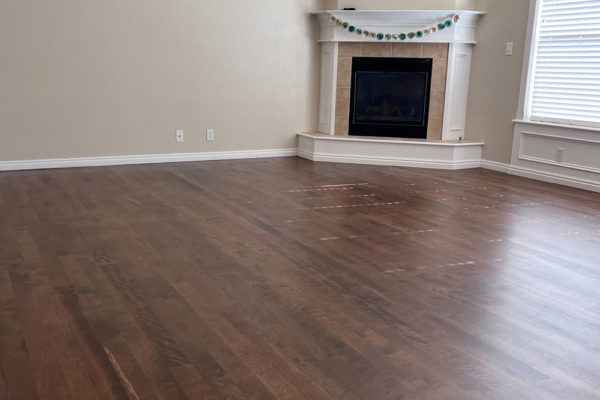 dark brown hardwood floors in living room with fireplace