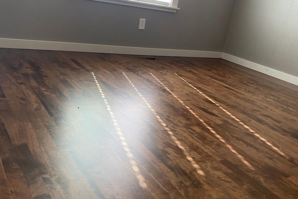 dark brown hardwood floors in clean bedroom