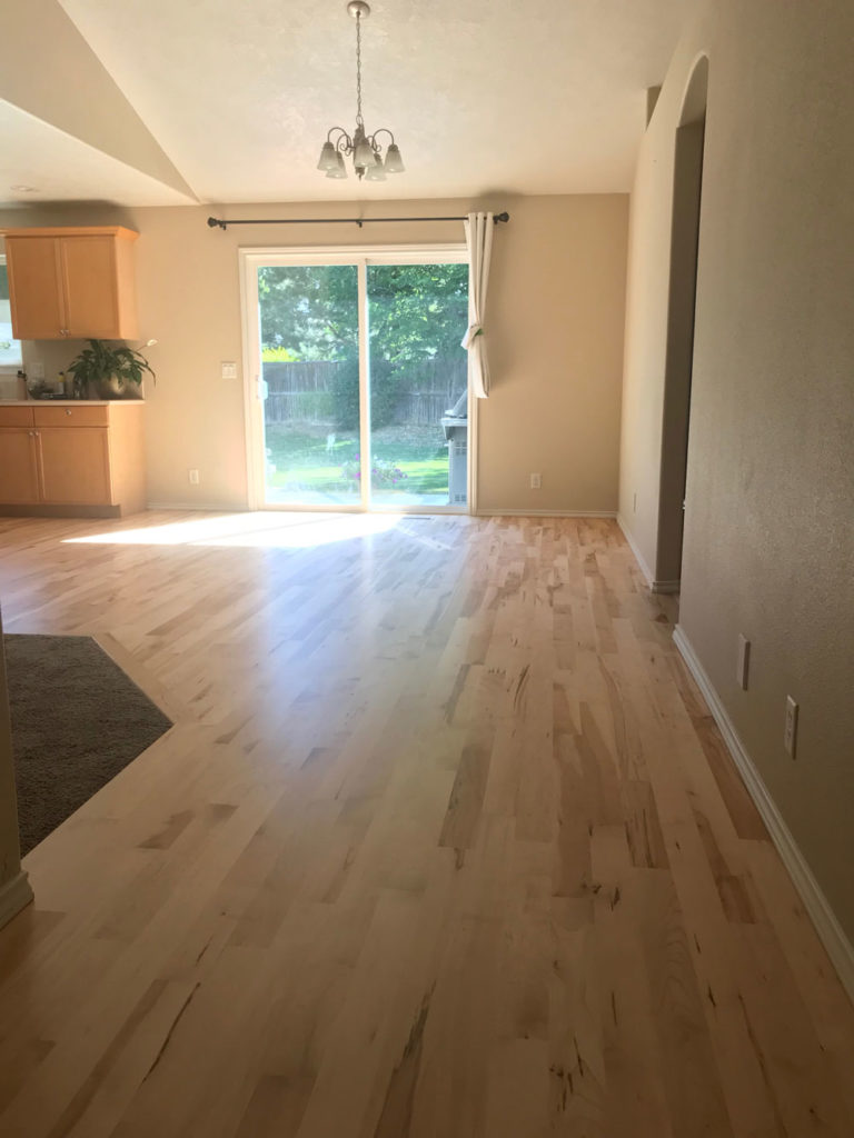 light colored hardwood floor in kitchen overlooking backyard