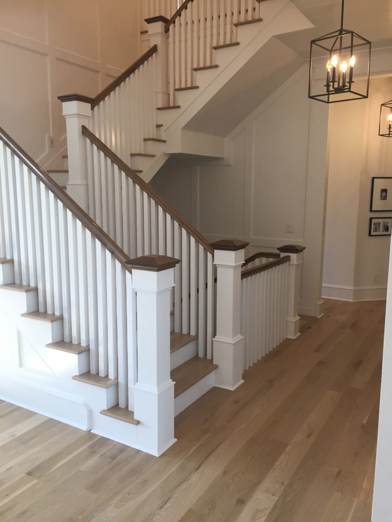 light oak hardwood floors near updated staircase