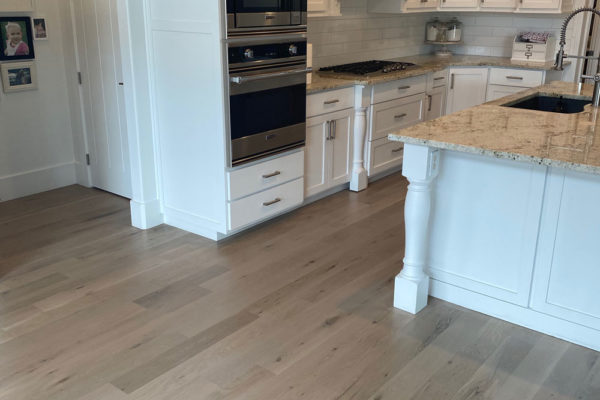 grey oak hardwood flooring in white kitchen
