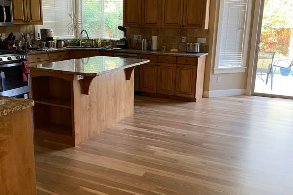 oak hardwood floors in kitchen and dining room with matching cupboards
