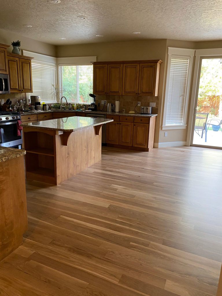 oak hardwood floors in kitchen and dining room with matching cupboards